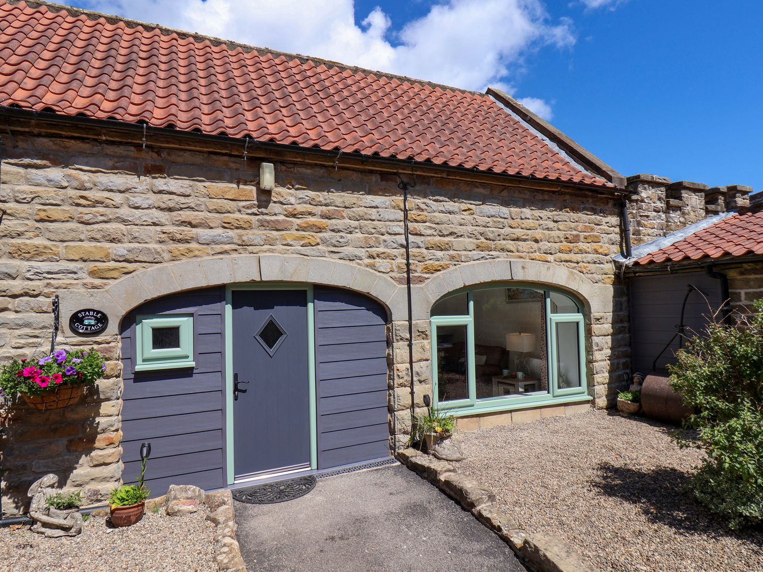 The entrance of a cottage with a doorway and a window at Wayside Farm Stable Cottage Cloughton near Burniston