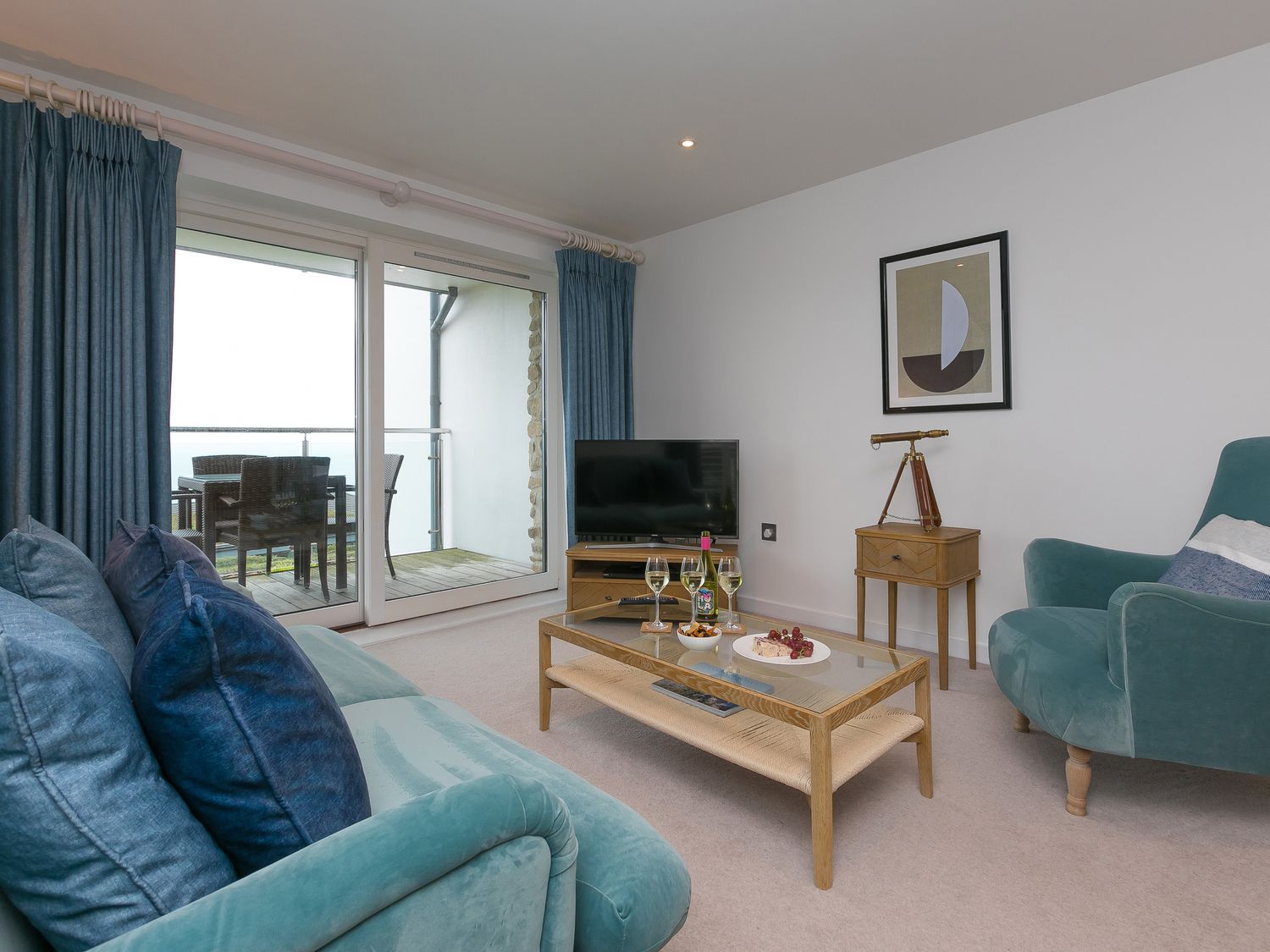 A living room with a television and coffee table at Far Cliffs St. Ives