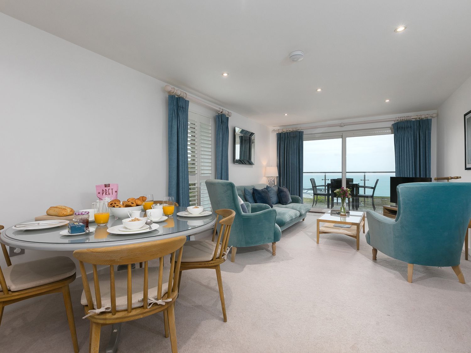 A dining room with a table set for breakfast at Far Cliffs in St. Ives
