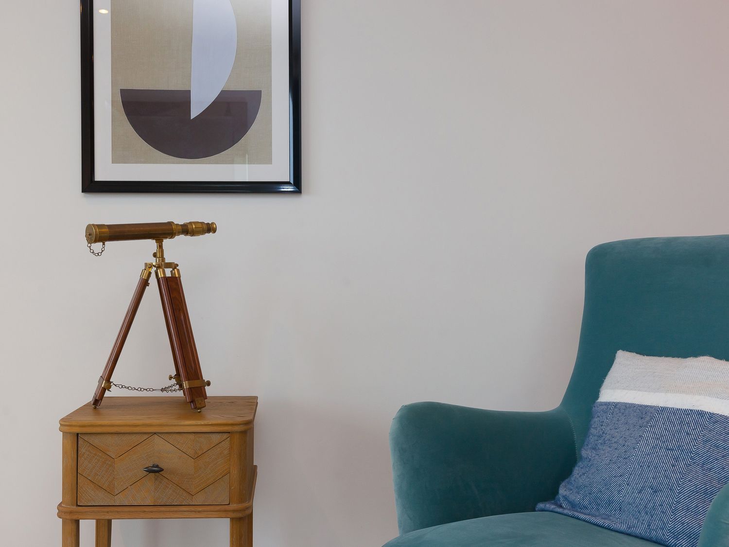 A living room with a telescope on a side table at Far Cliffs in St. Ives