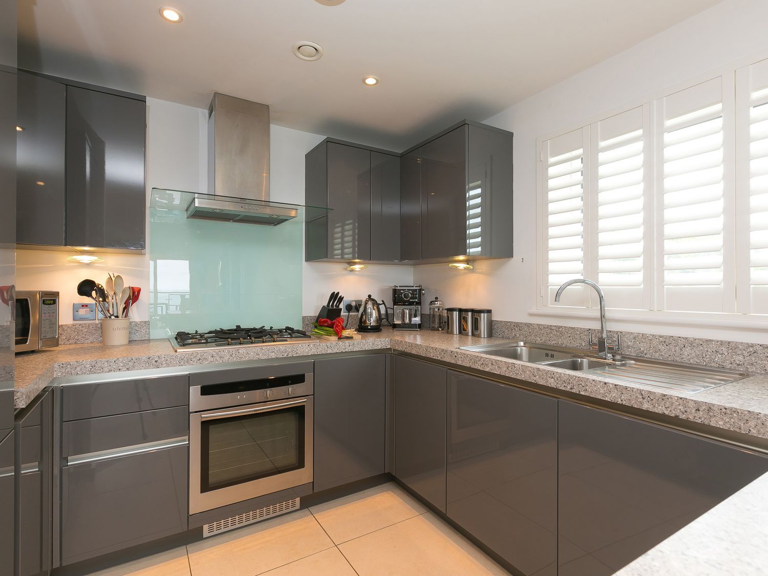 A kitchen with cabinets, sink, stove, and appliances at Far Cliffs in St. Ives