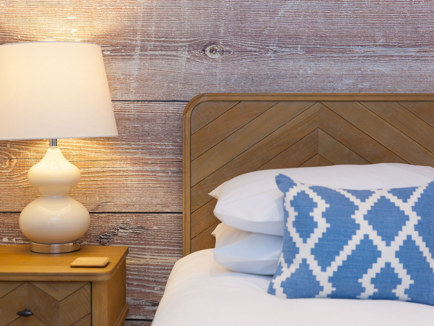 A bedroom with a bed and lamp at Far Cliffs St. Ives