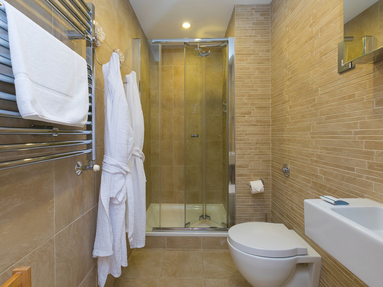A bathroom featuring a shower, toilet, and sink at Far Cliffs in St. Ives