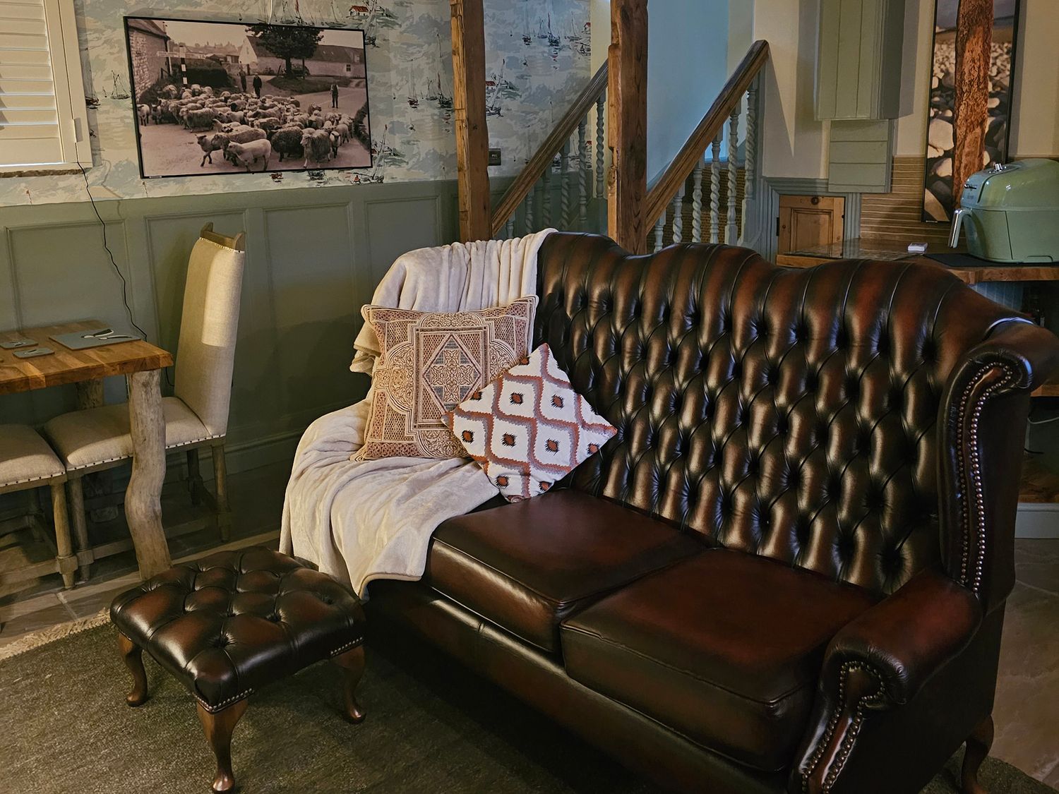 A living room with a sofa and dining table in Driftwood Bridlington