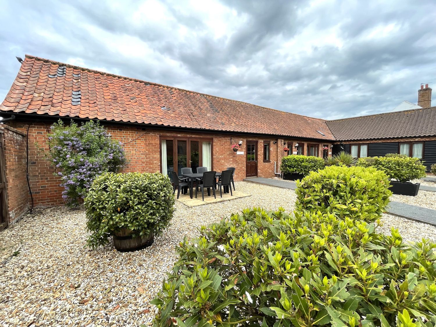 A garden with outdoor furniture and plants at Beechwood in Wood Norton near Foulsham
