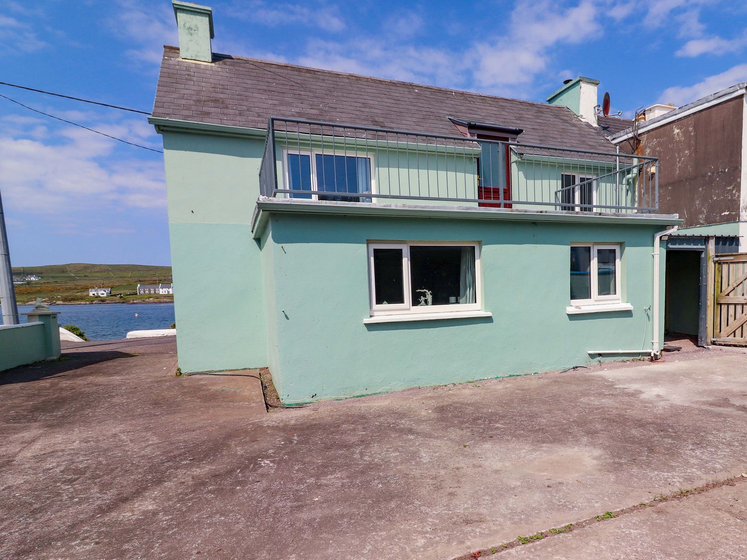 A house with a balcony and windows at O'Conells in Portmagee