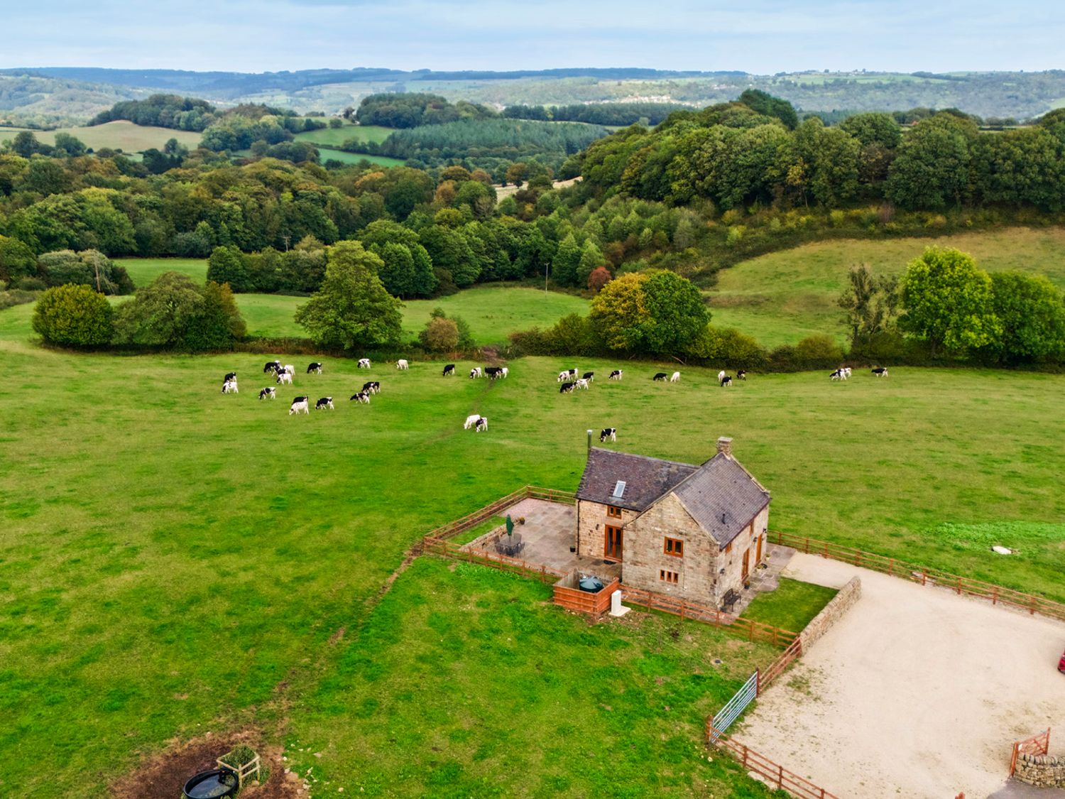 An aerial view of a house with cows in a field at Lane Head Cottage Alderwasley near Wirksworth