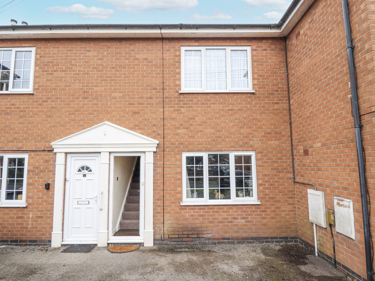 An exterior view of a house with a door and windows at 5 Links Court in Skegness