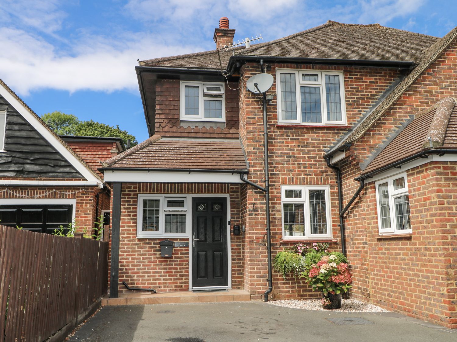 A house with a front door and garden at Sunnyfield Cottage 