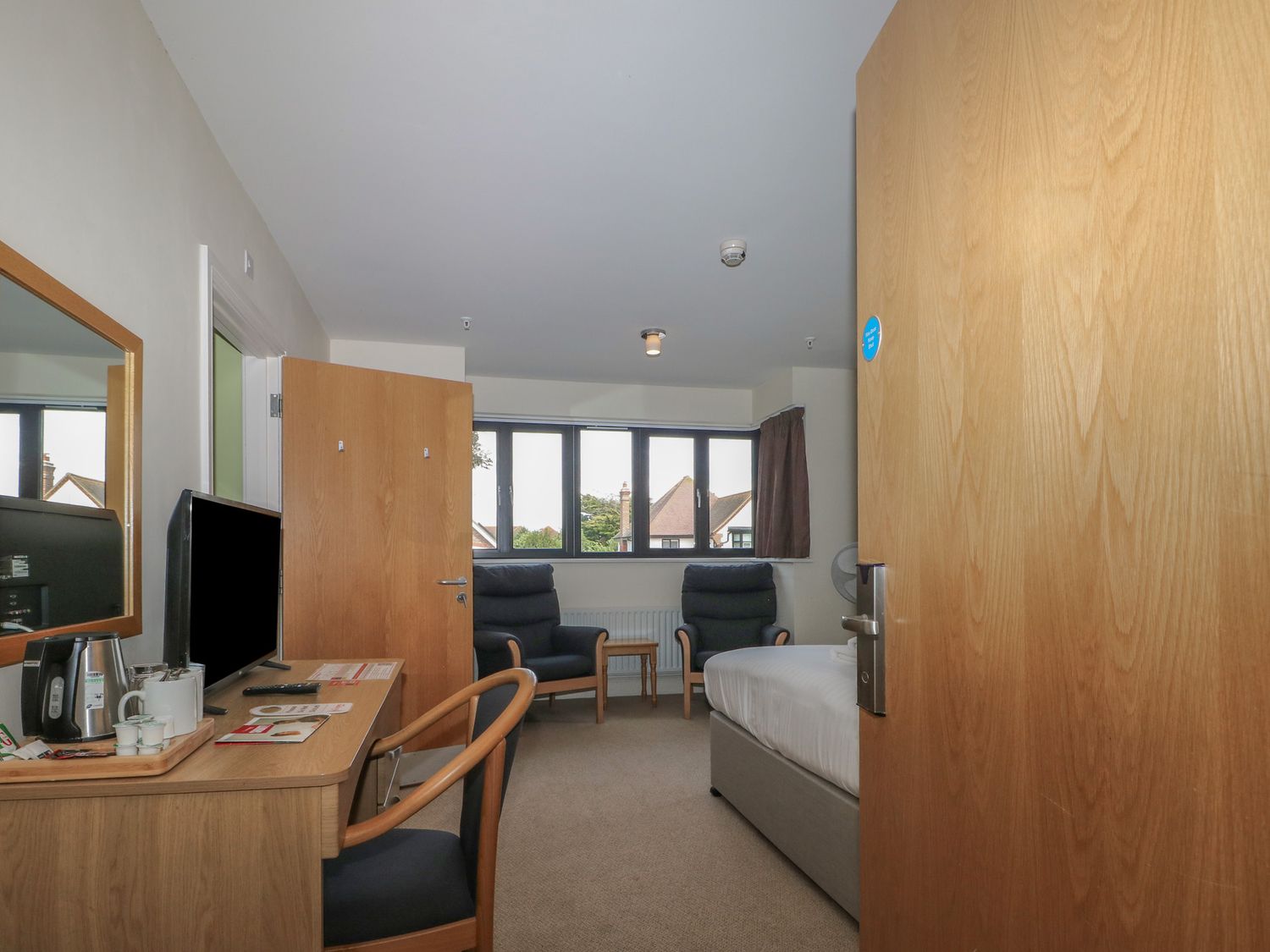 A bedroom with a bed and television at Bedroom 18 Littlehampton
