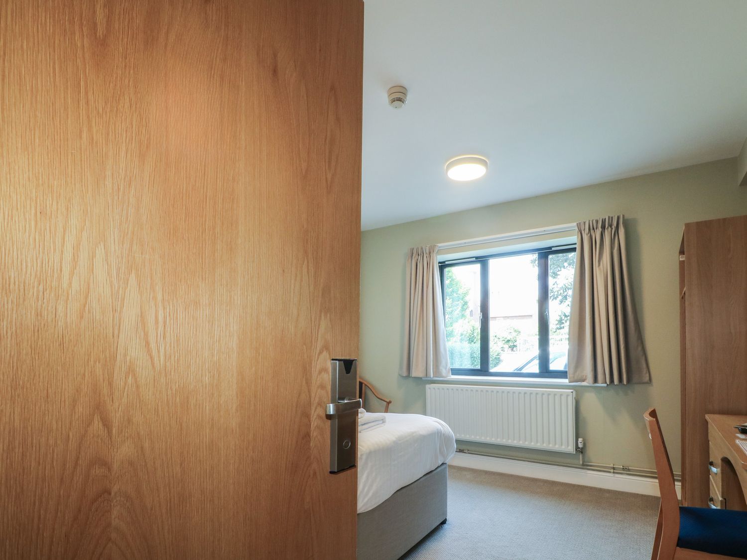 A bedroom with a window, bed, and desk at Bedroom 1 in Littlehampton