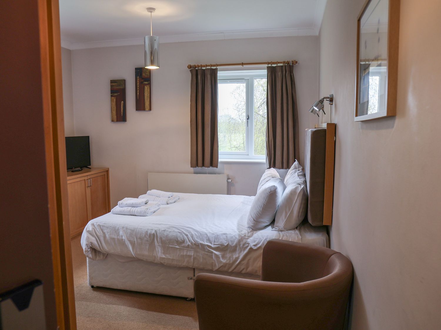 A bedroom with a bed and television at Bedroom 33 
