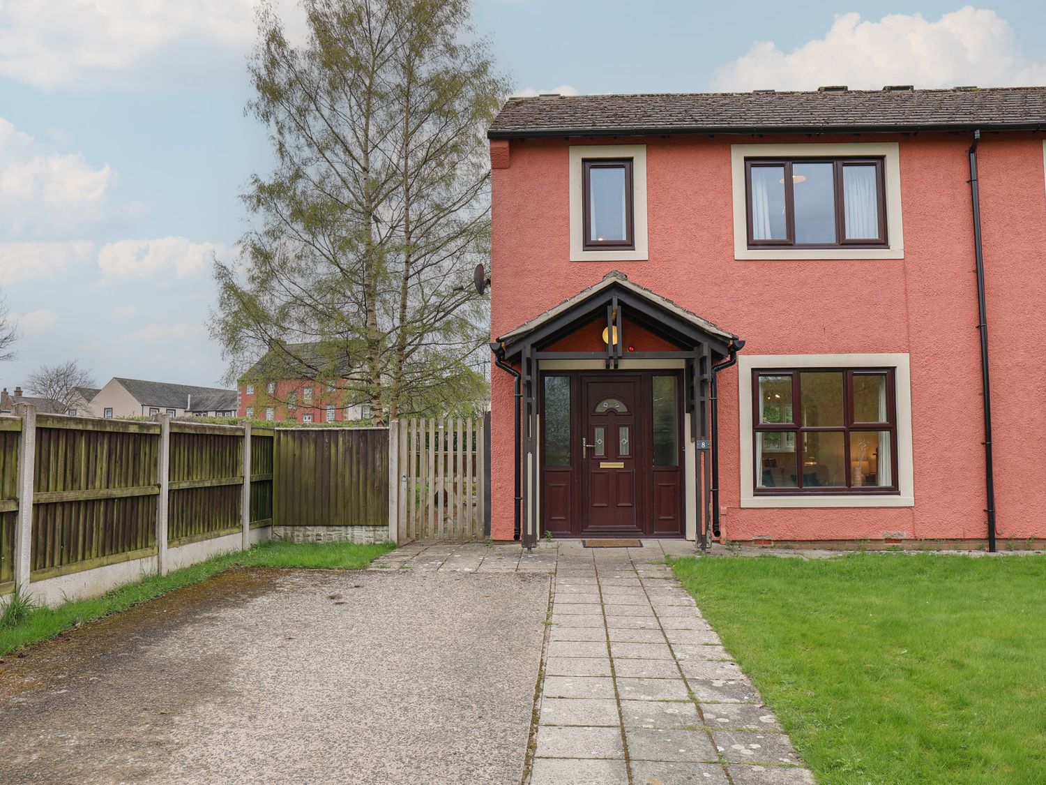 A house with a front door and garden at House 8 Eamont Park Penrith