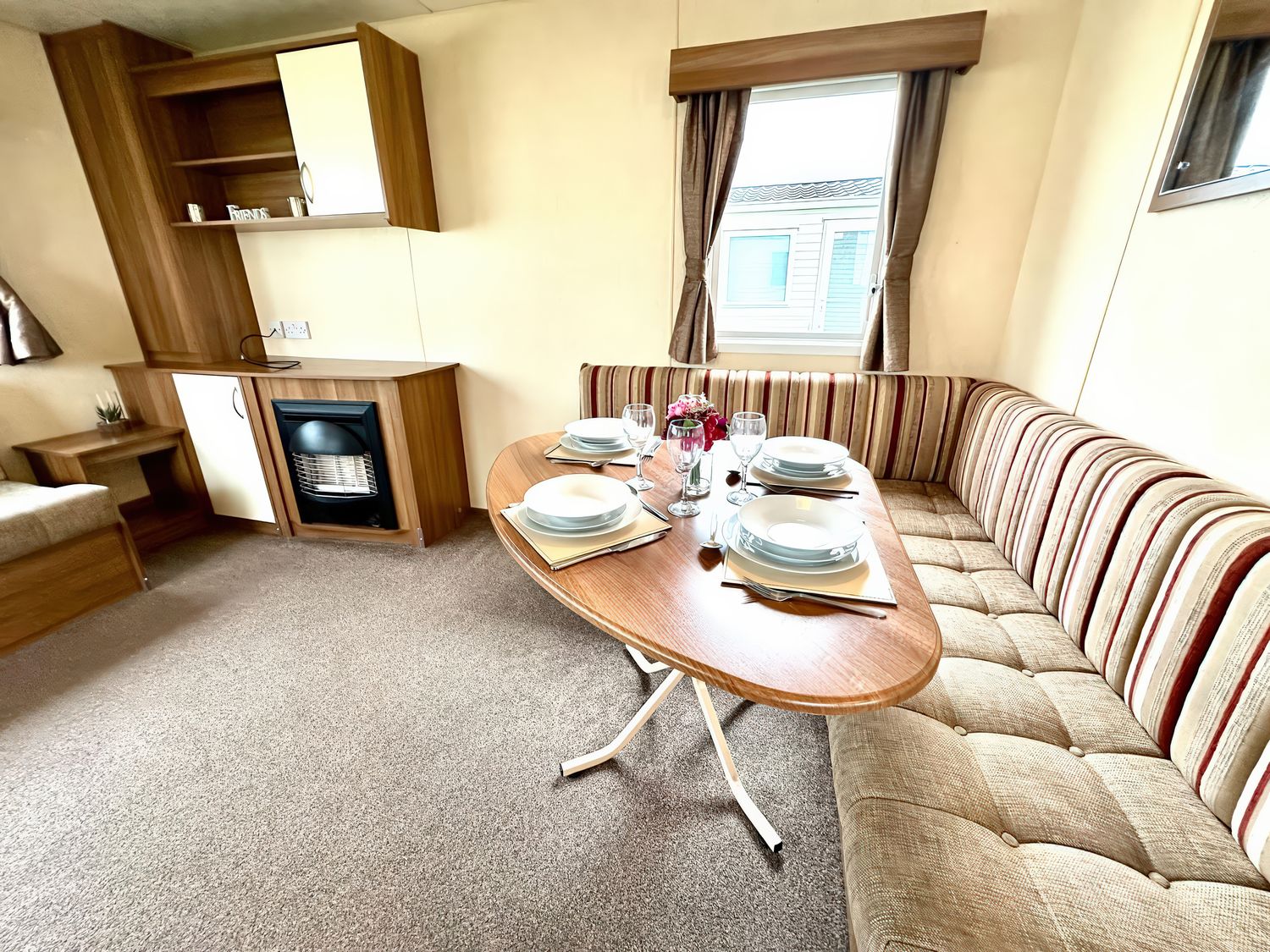 A dining area with a table set for meals at Chamki Lodge in Whitley Bay