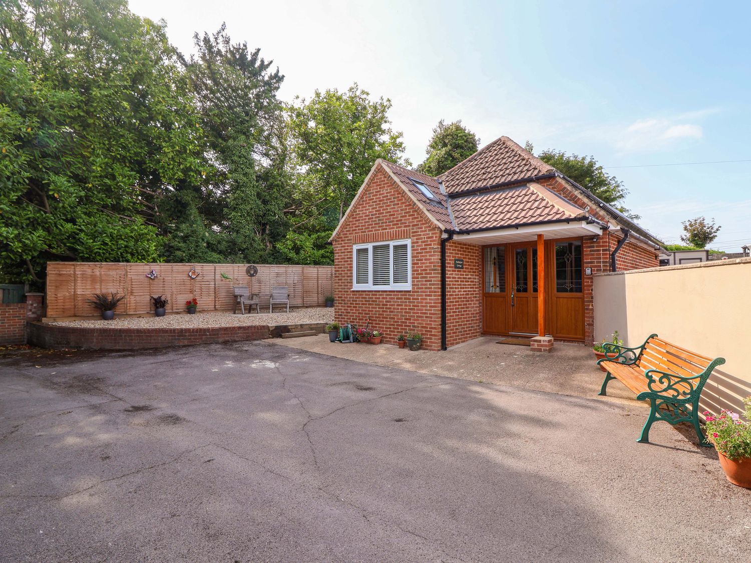 An outdoor area with a house and parking space at Poddington Cottage in 