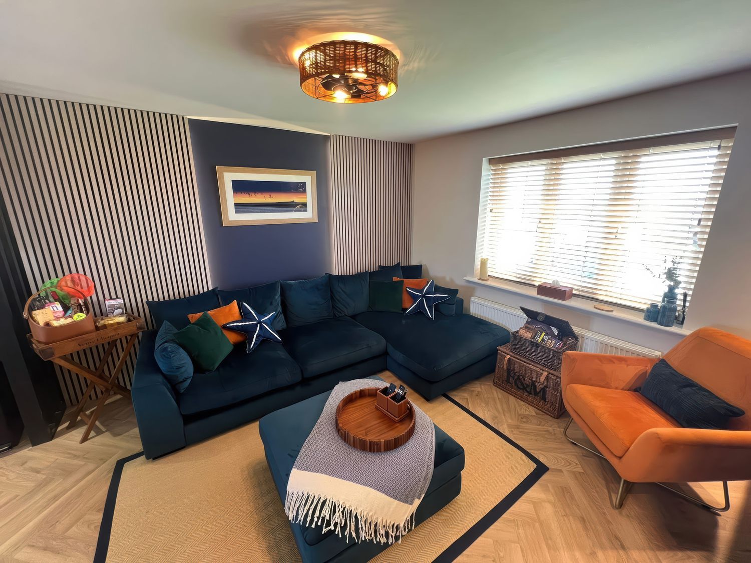 A living room with a sofa and armchair at Craster House Seahouses