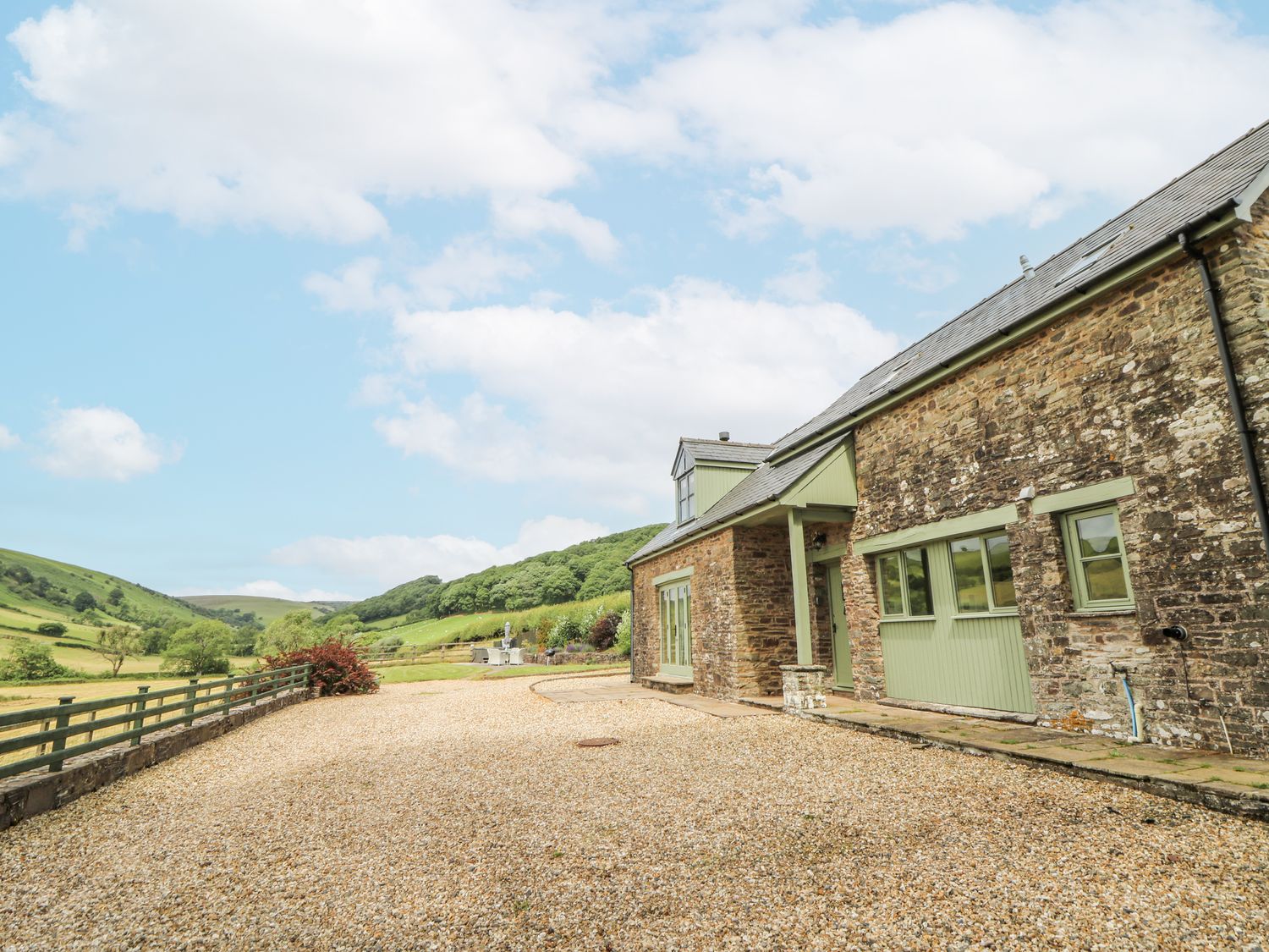 A stone house with a gravel driveway at Waun Yscir Merthyr Cynog near Brecon