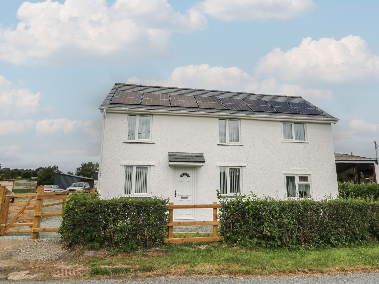 A house with solar panels and a hedged garden at Glandwr House in Llandrindod Wells