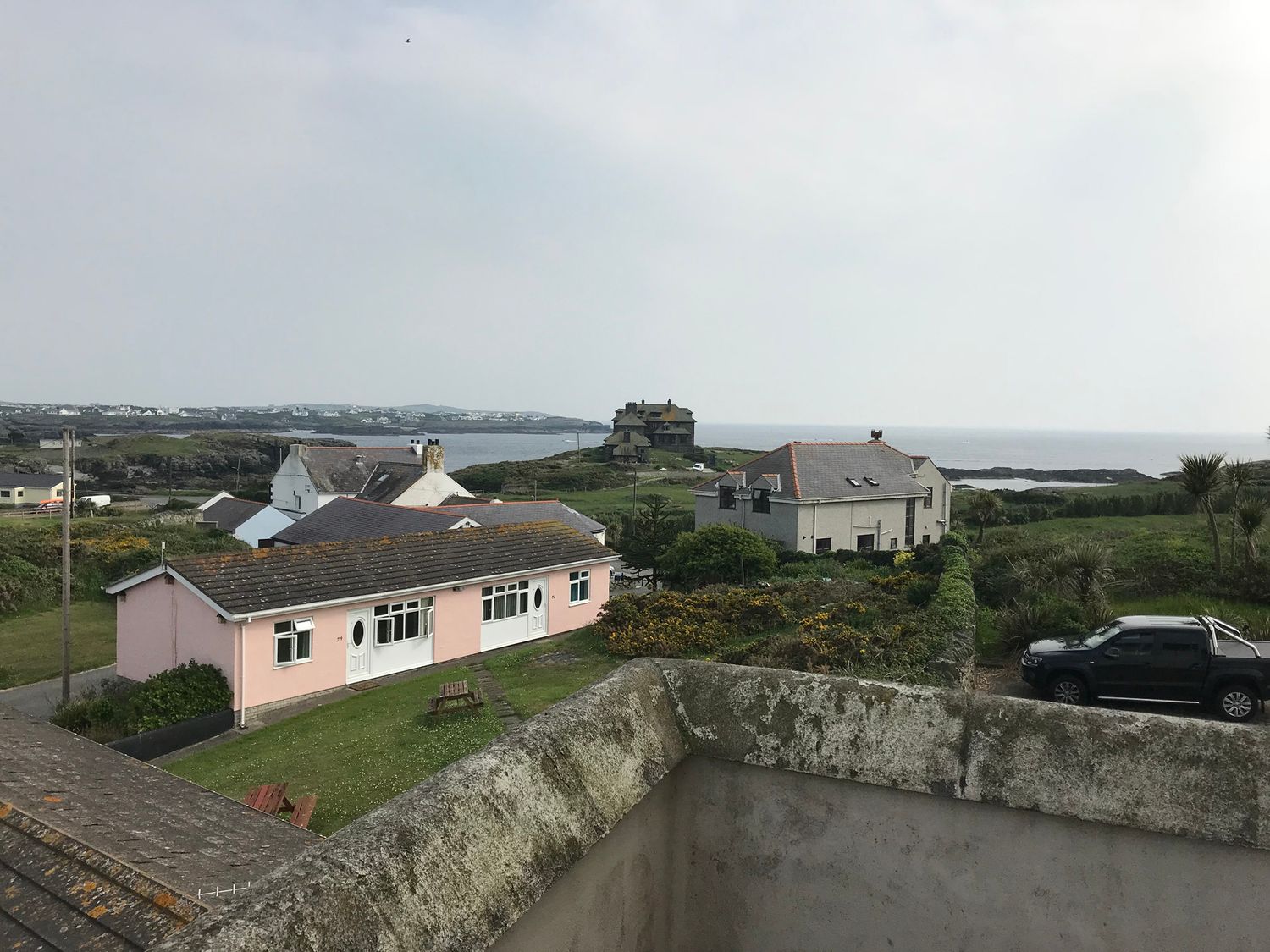 A view of houses and the ocean at Sea Views No 8 Plas Darien in Trearddur Bay