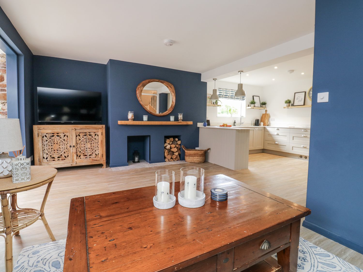 A living room with a television and a coffee table at 1 Island View Thurlestone