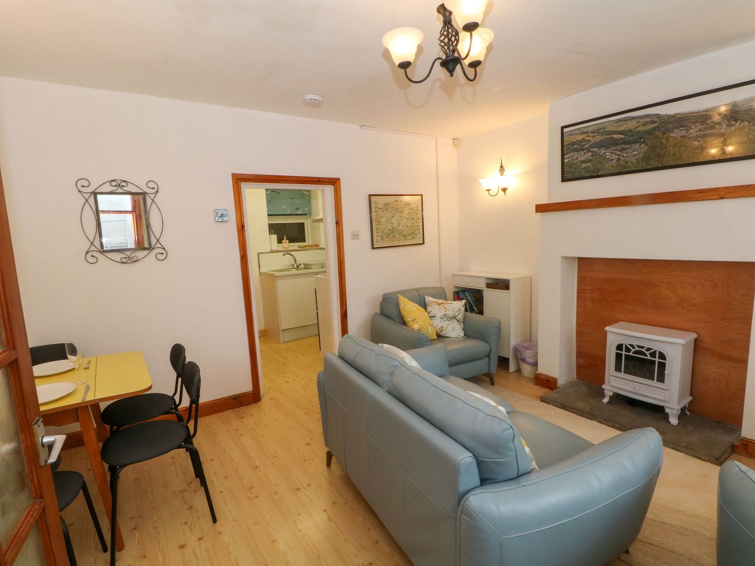 A living room with a sofa and a table at Holme Cottage Hebden Bridge