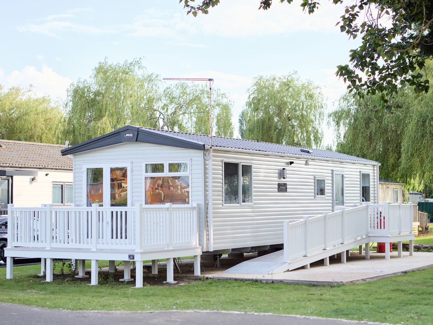 A mobile home with a deck and steps at Meadowview - Billing Aquadrome