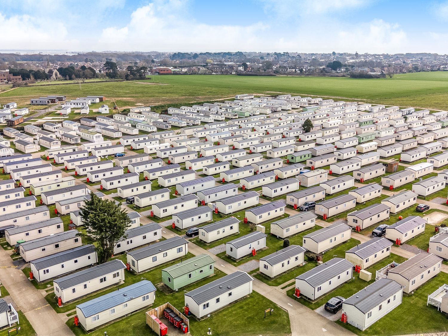 A large array of identical caravans with roads and green spaces at Mariner's Meadow - Hayling Island in Hayling Island Holiday Park
