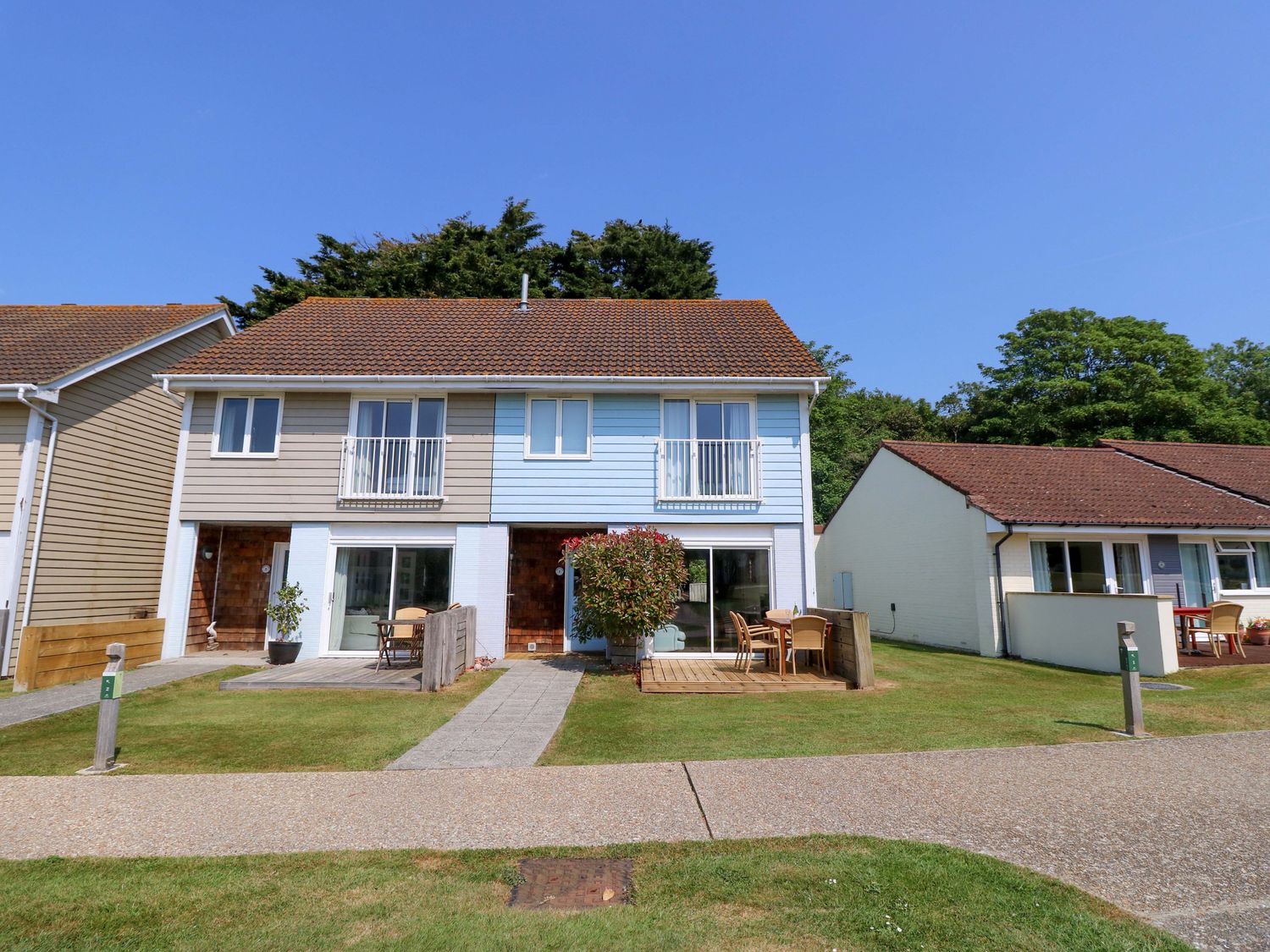 A semi detached house with two patios and outdoor furniture at Whitfield P1 in Yarmouth