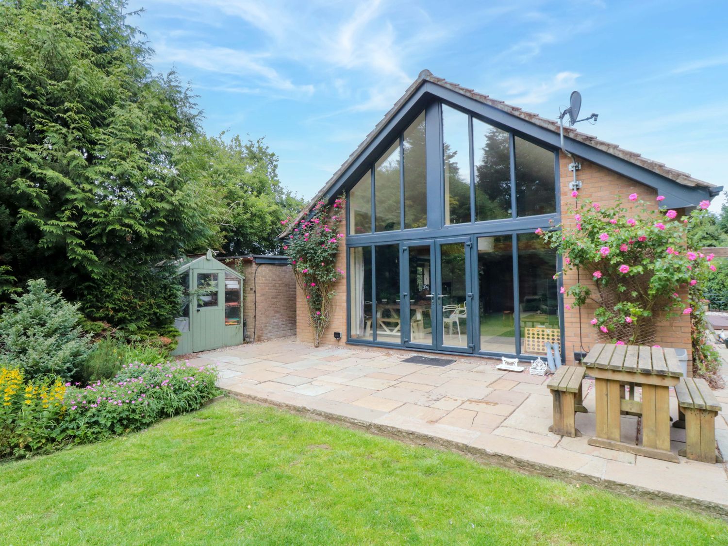 A house with large windows and garden features at Lawnswood