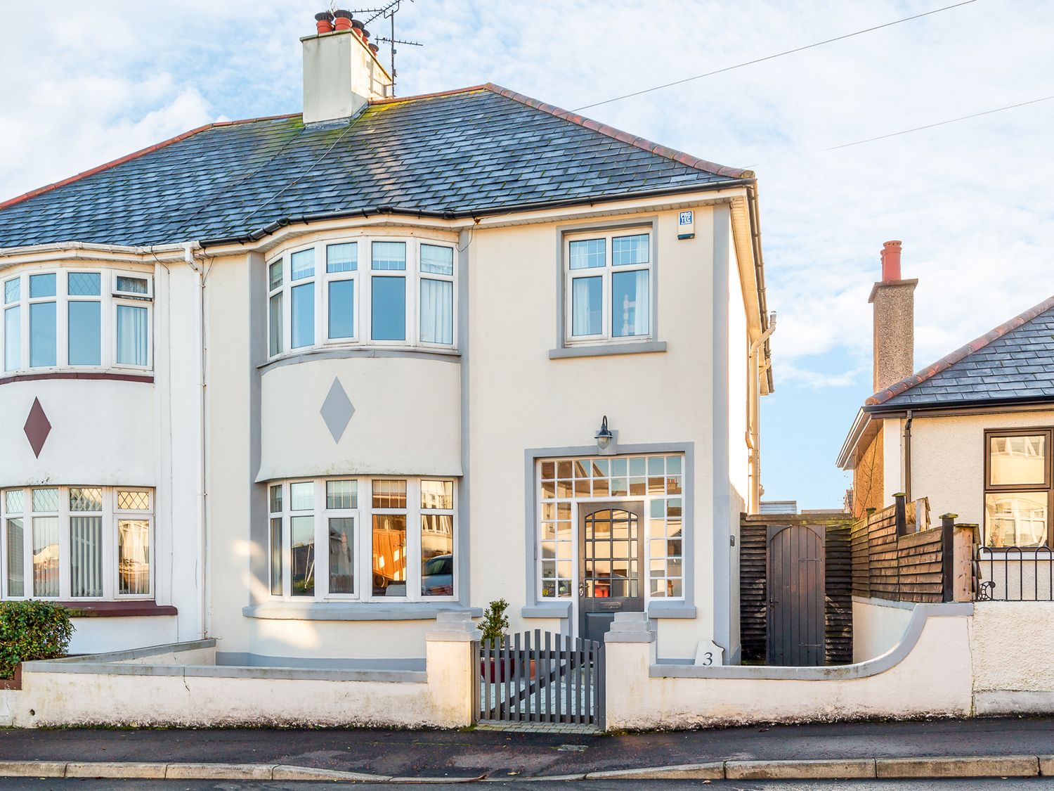 A house with multiple windows and a front garden at Tranquility 