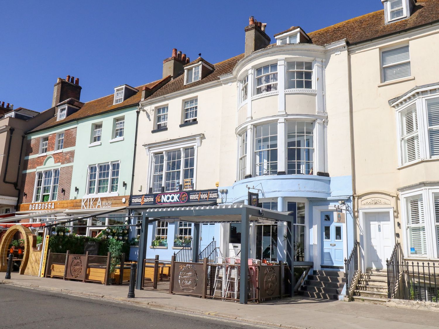 A restaurant building with outdoor seating at The Beach Condo in Weymouth