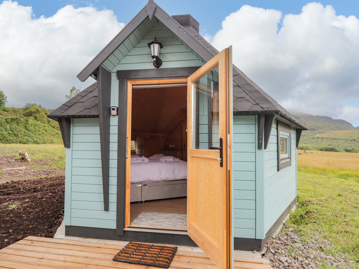 A cabin with an open door leading to the interior at Little Luxe Lodges 2 Balmacara near Kyle of Lochalsh