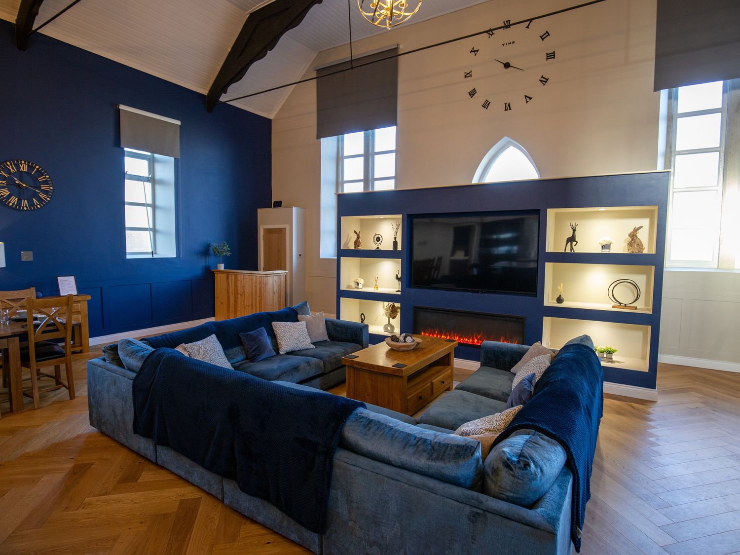 A living room with a sofa, coffee table, and television at Moorsholm View in Saltburn-by-the-Sea