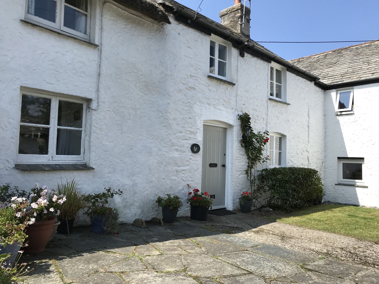 An exterior view of a house with flower pots at Trevean in Crackington Haven