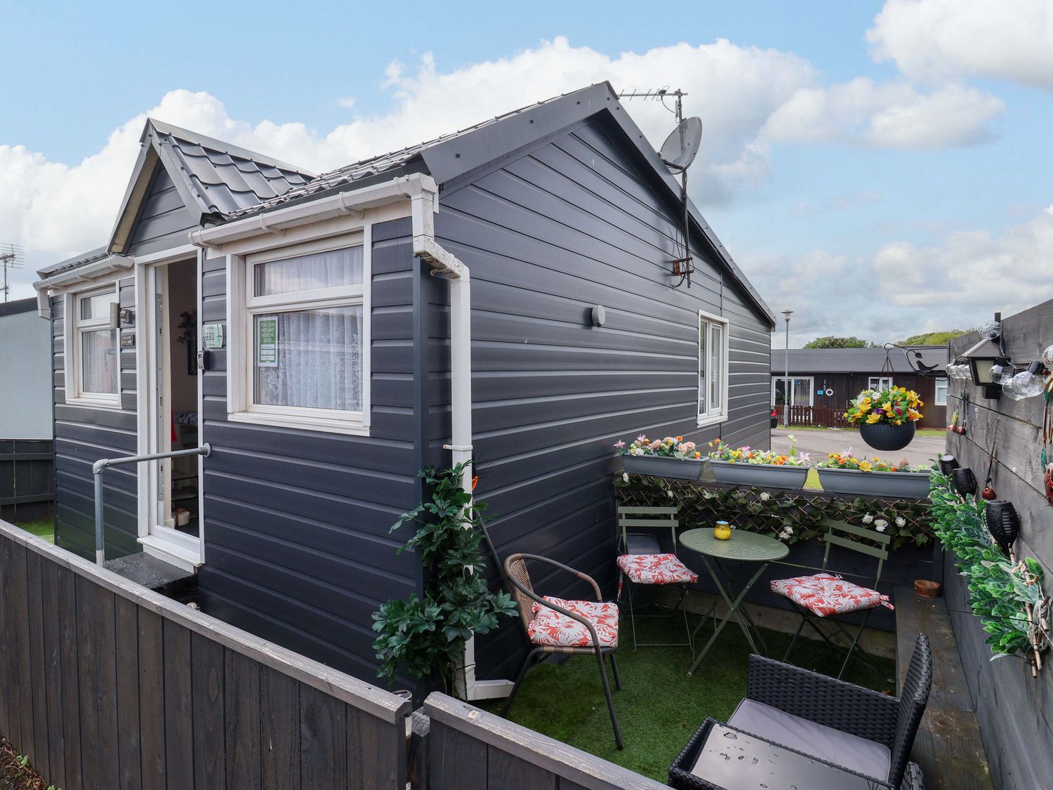 An outdoor seating area with a table and chairs at Chalet 231 in Bridlington