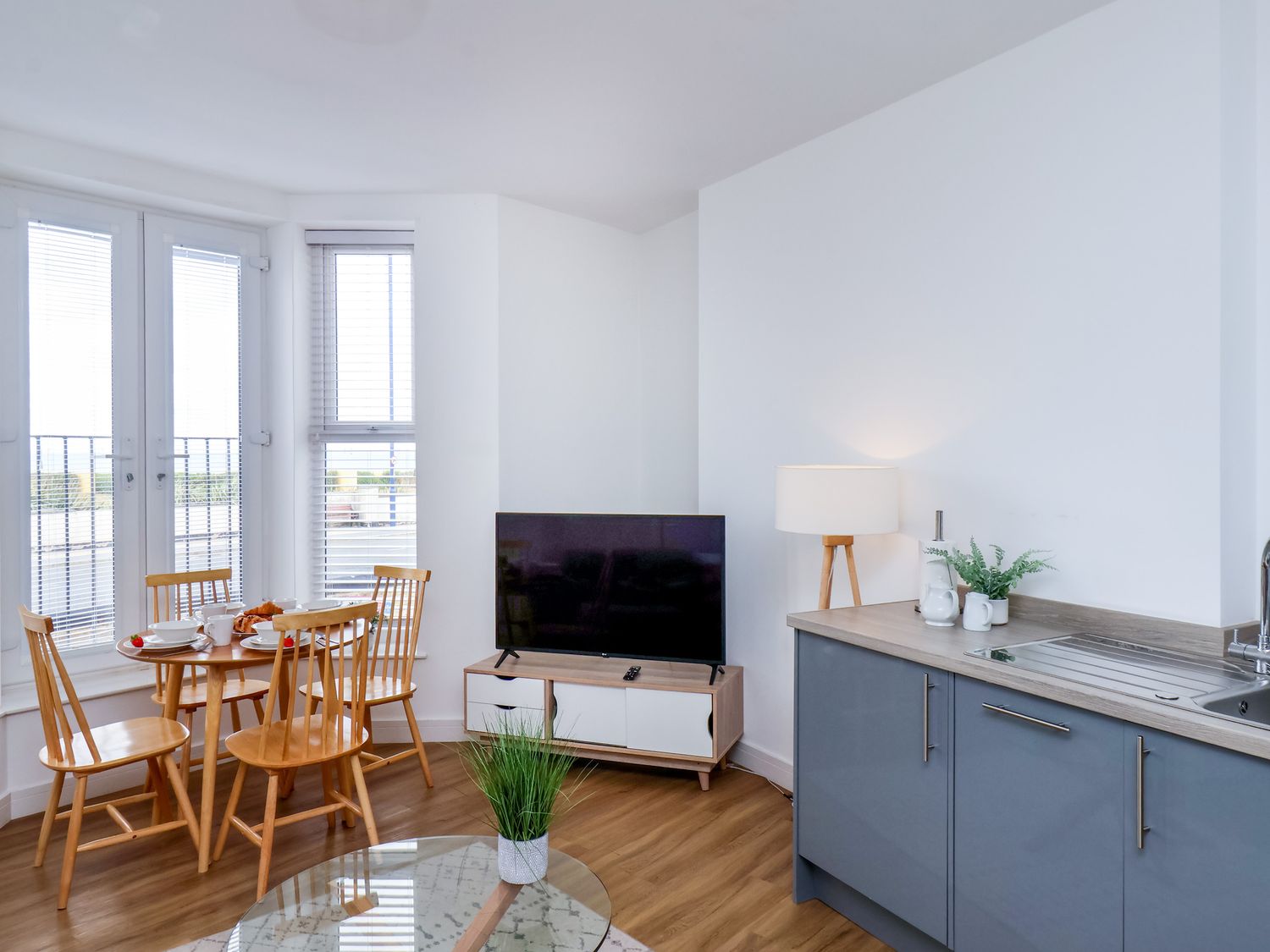 A living room with a dining table and tv at Apartment 1 (2 bed) Redcar