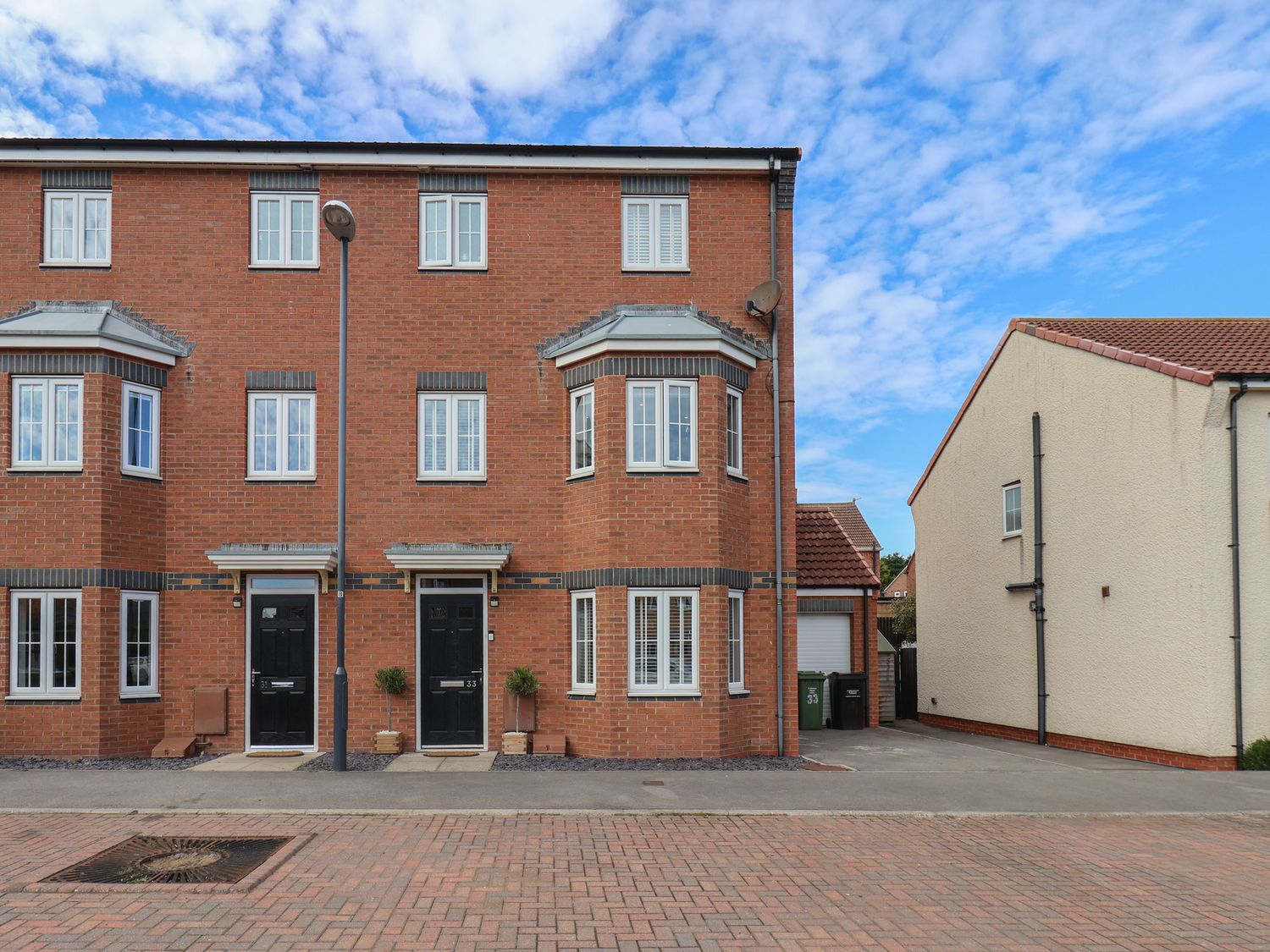 A building with multiple windows and doors at 33 Murrayfield Gardens in Whitby
