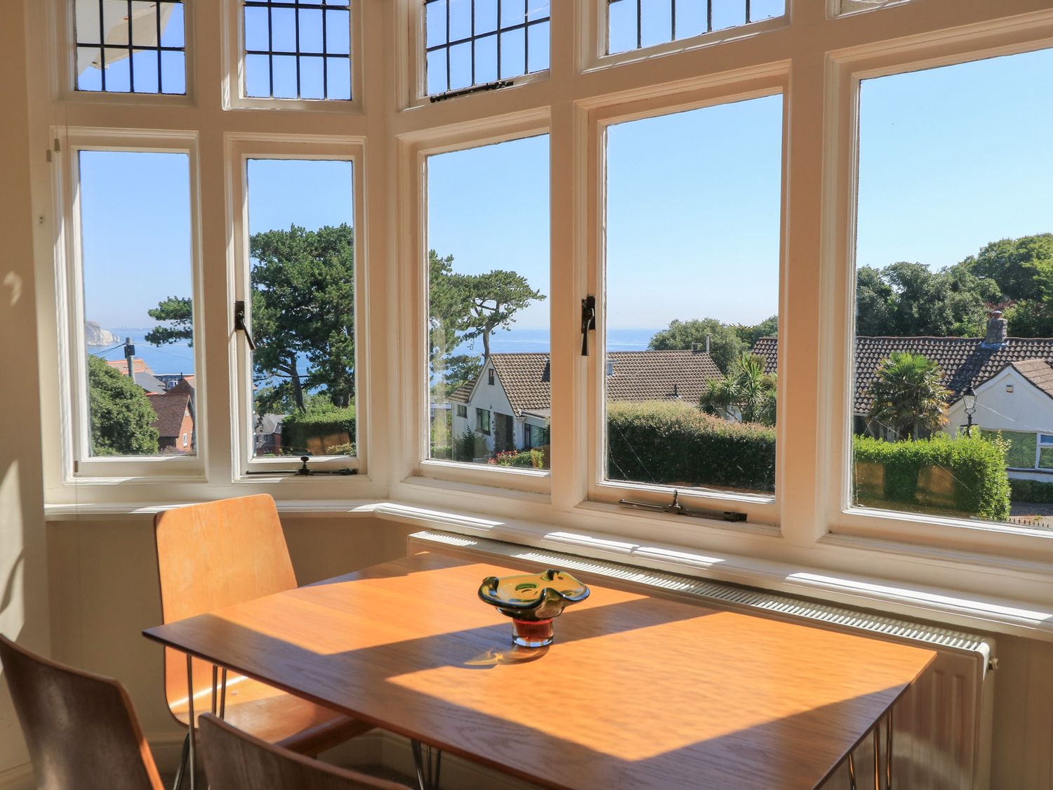 A dining room with a table and chairs at Purbeck Vista in Swanage