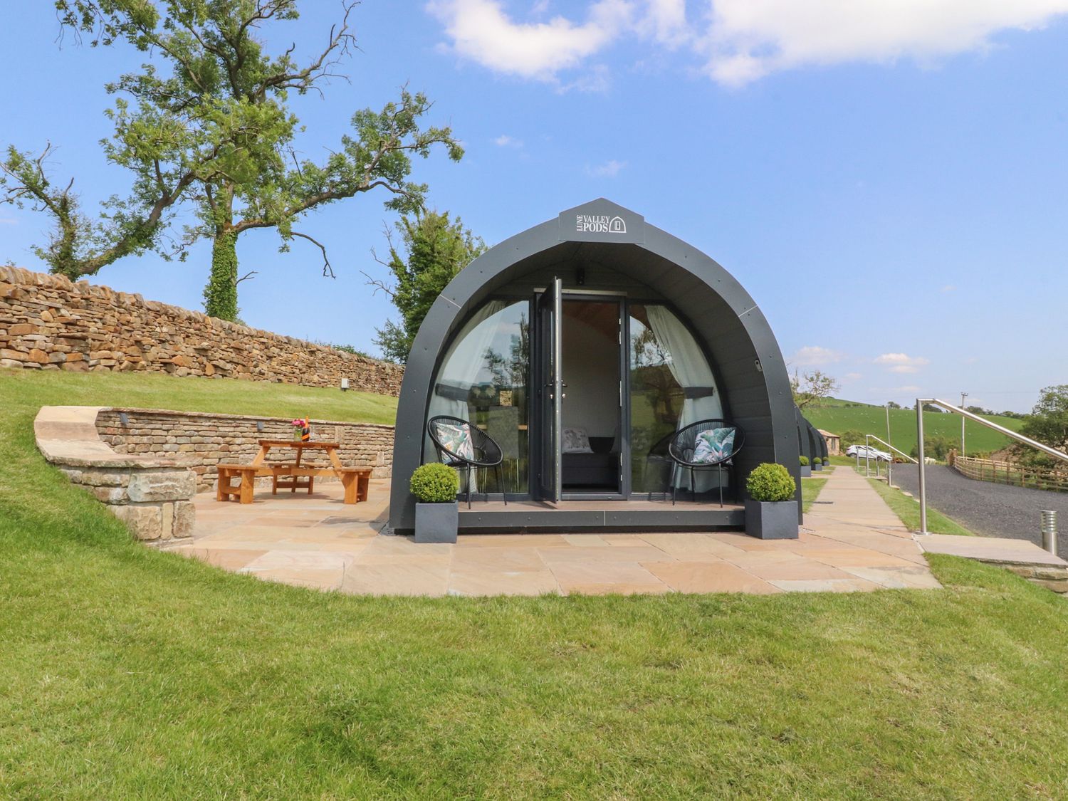 A glamping pod with outdoor seating at Pendle in Nelson