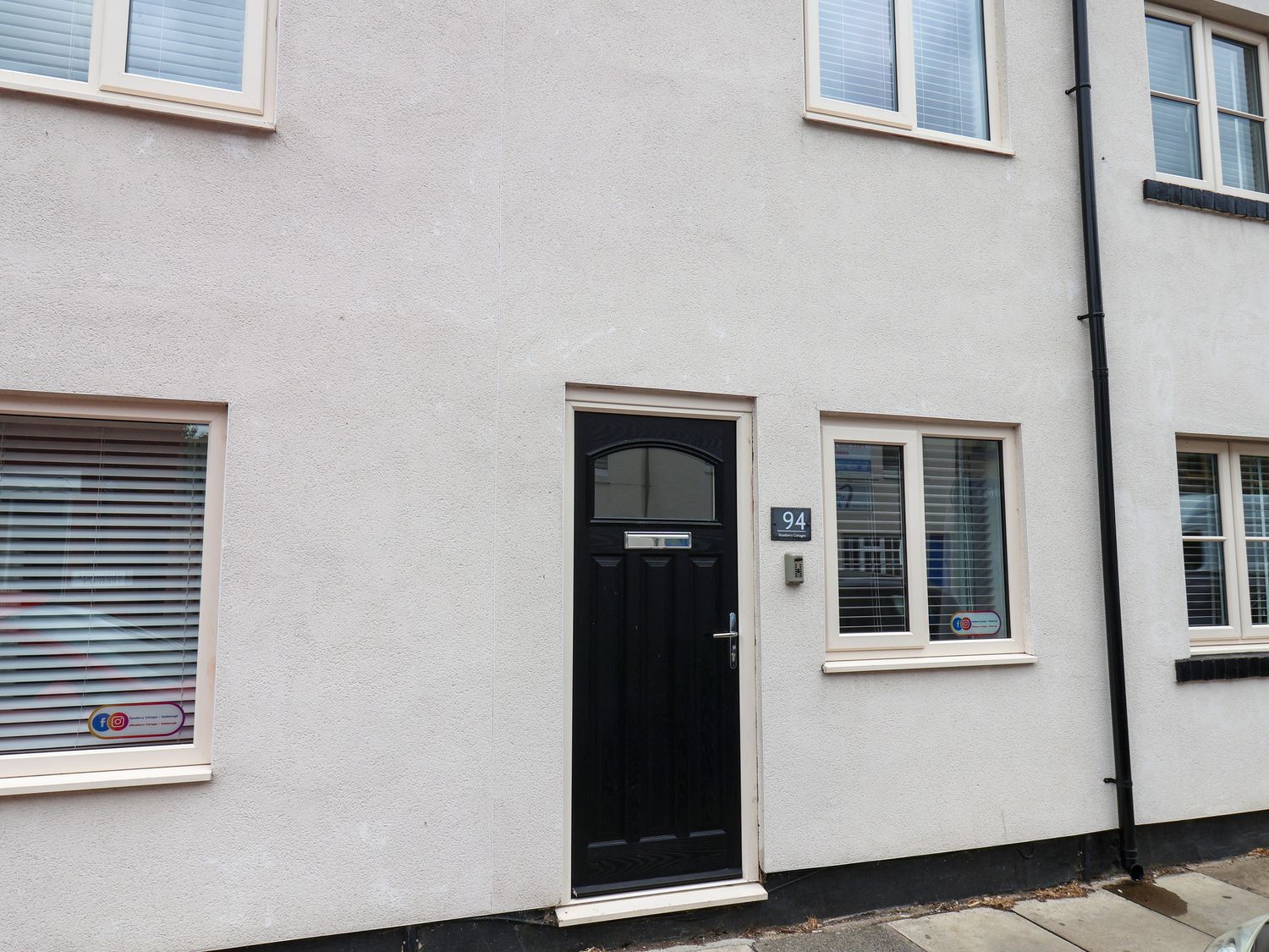 Front of a house featuring a black door and windows at 94 Church Street in Guisborough