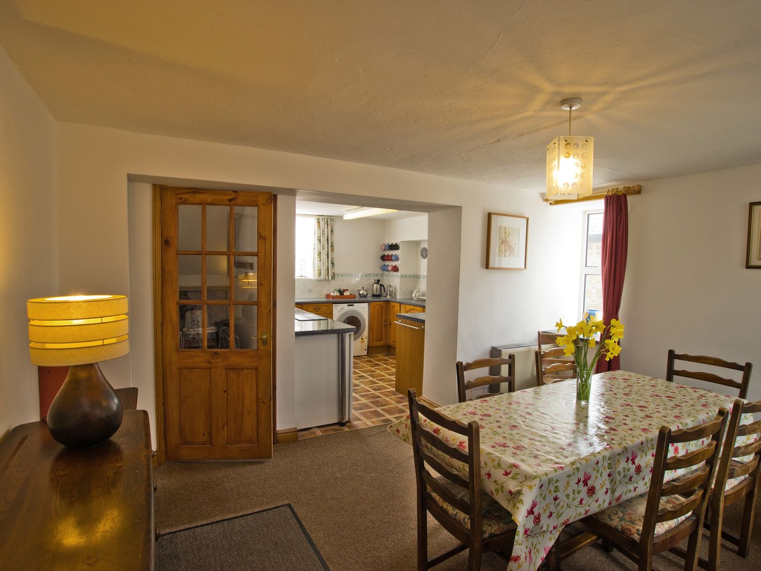 A dining room with a wooden table and chairs at Chyandaunce in Gulval