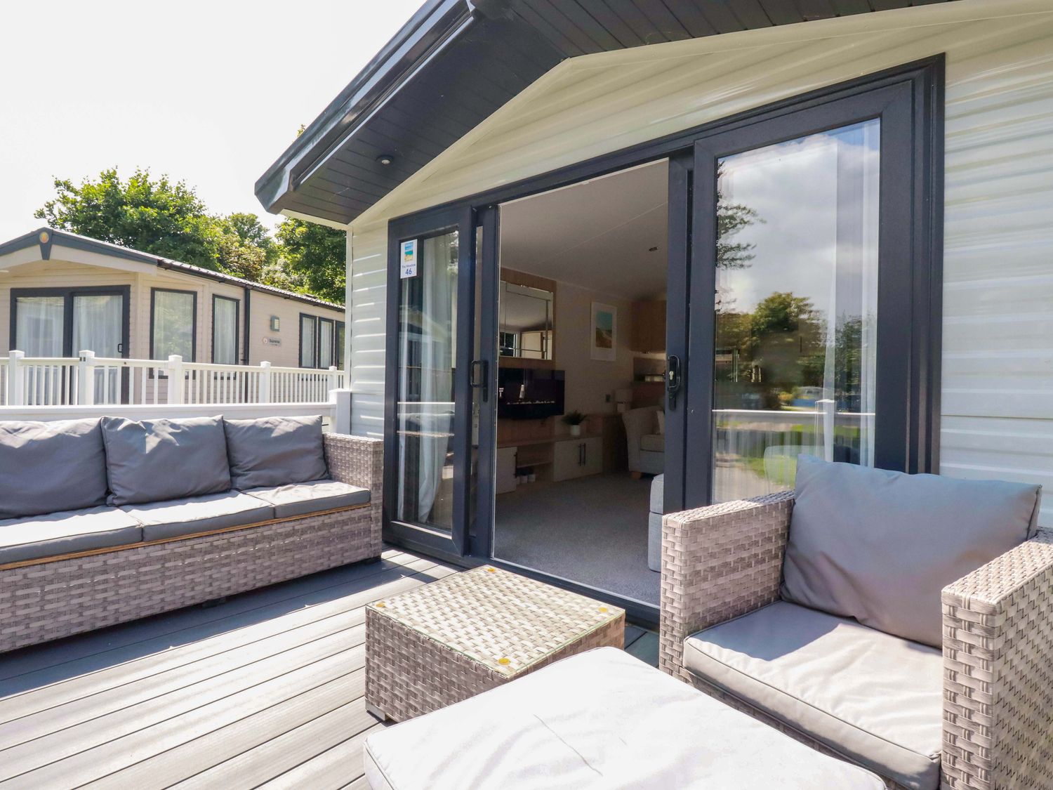 An outdoor patio area with a couch and table at Meadow 46 in Newquay