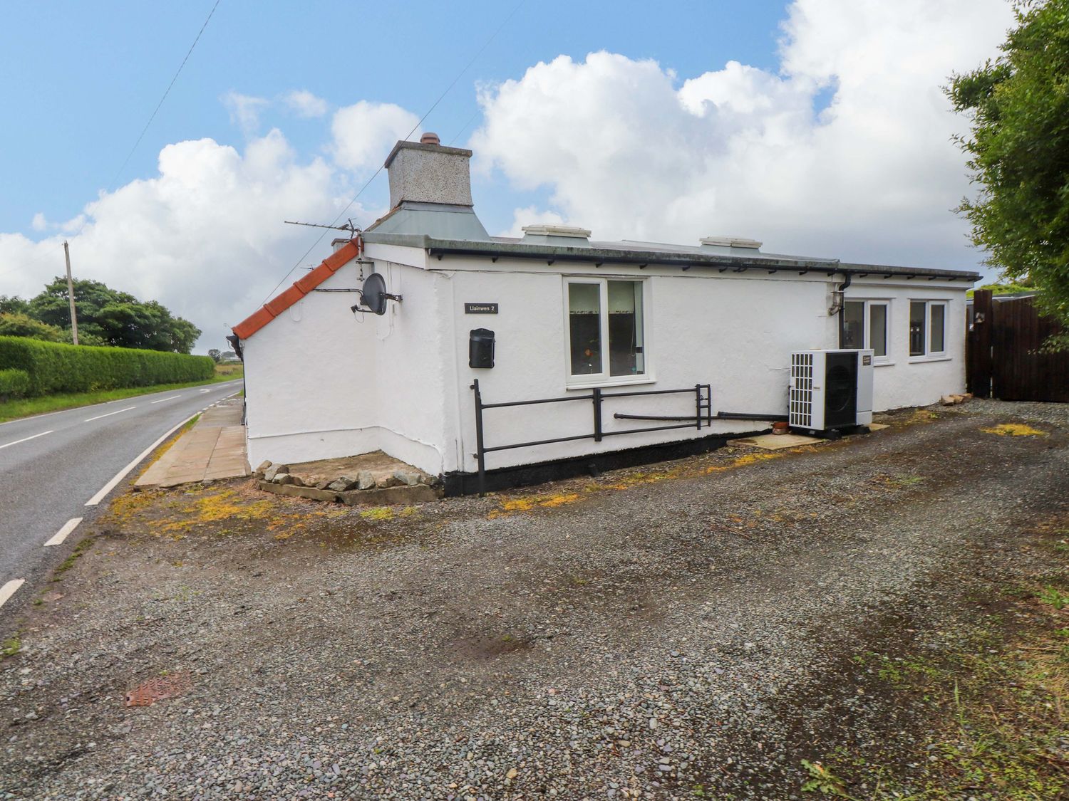 A house with windows and an air conditioning unit at 2 Llainwen Ty Croes