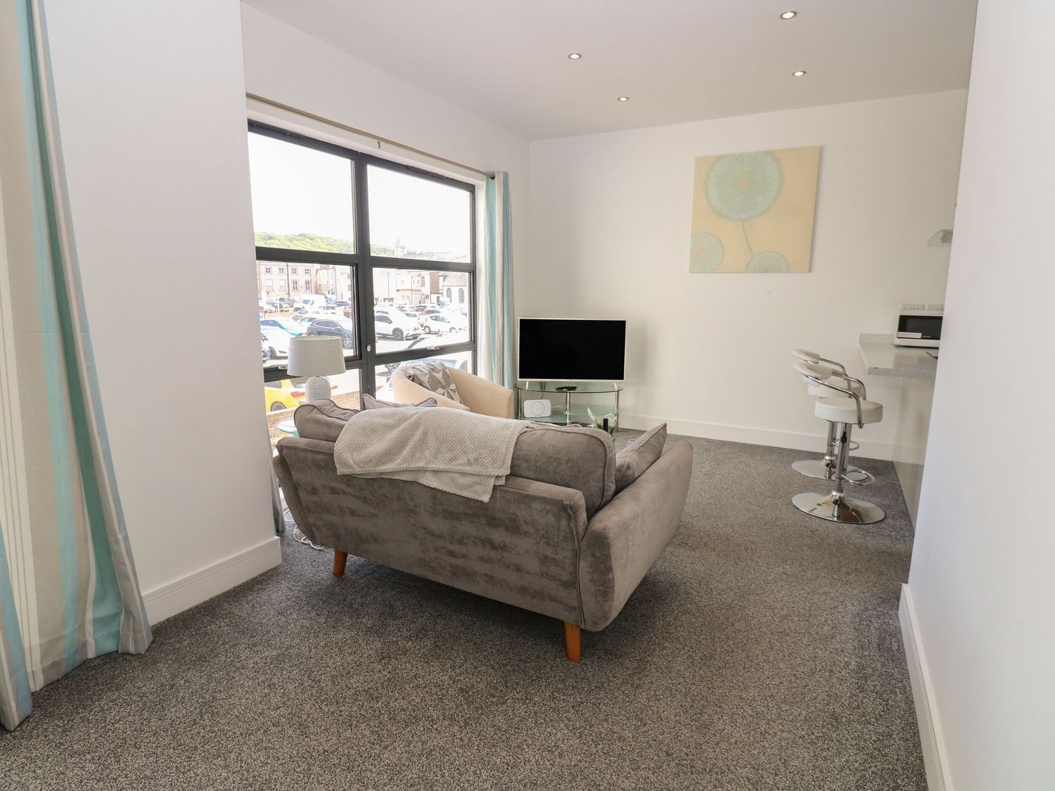 A living room with a sofa and television at Harbour View in Whitehaven