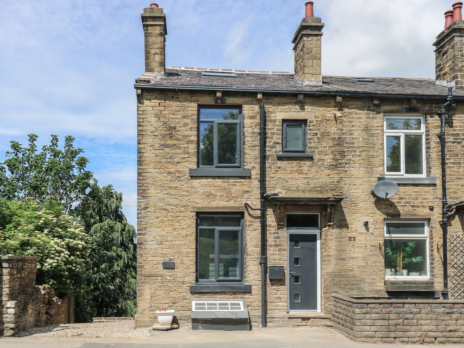 A house exterior with windows and a front door at Myrtle Loft in Keighley