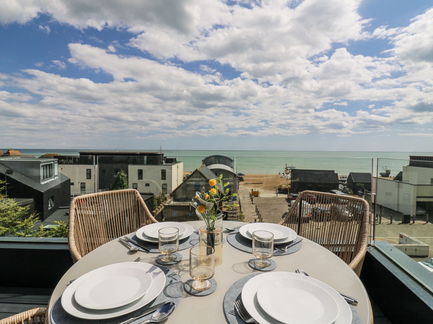 An outdoor dining area with a view of the beach at Flat 4 in Hythe