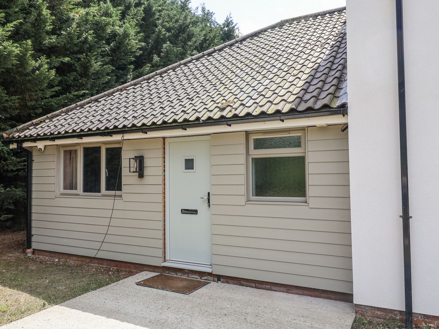 An entrance to a property with a front door and windows at Annexe in Colchester