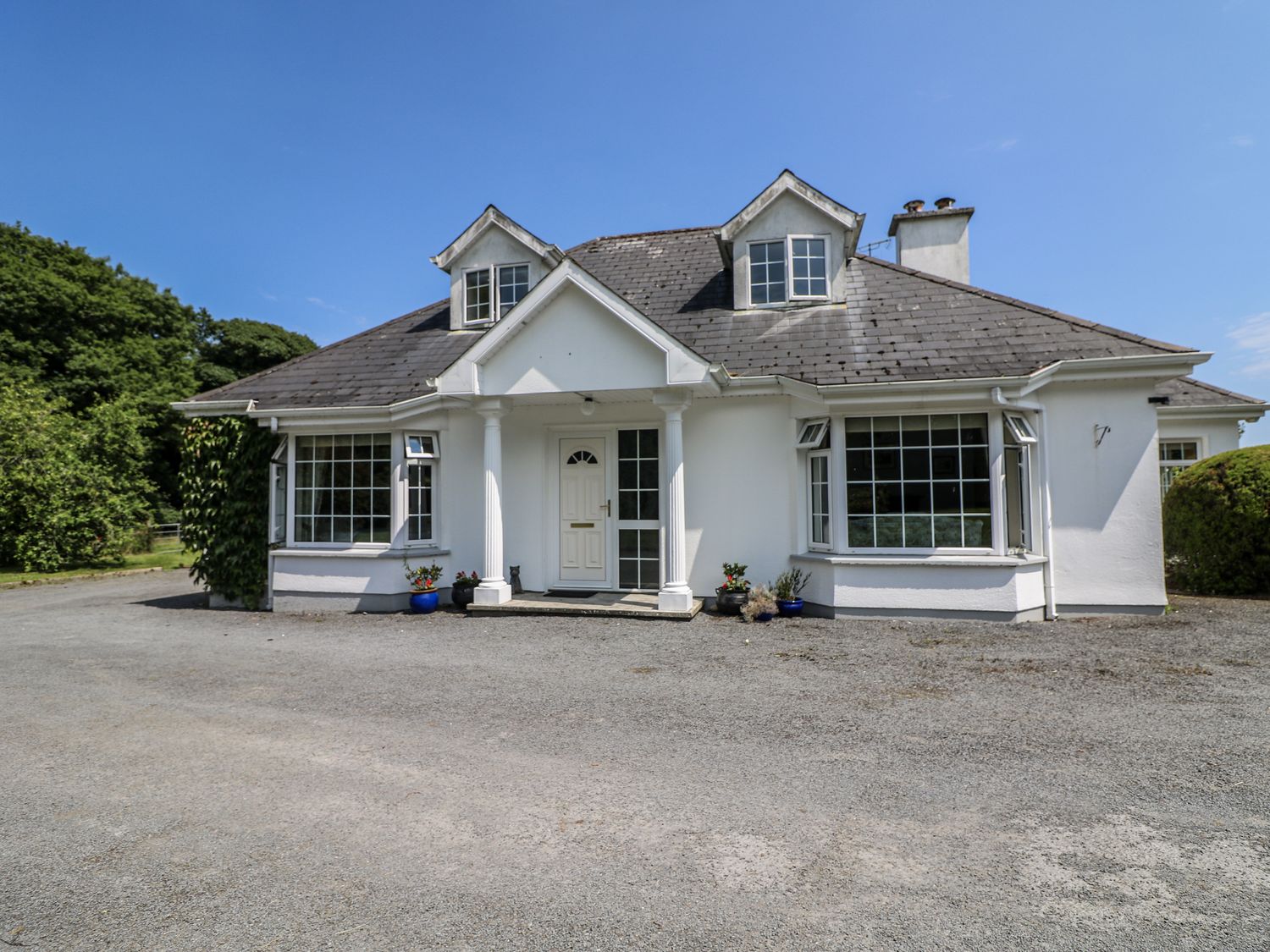 A house with a front door and windows at Knockroe Lodge in 