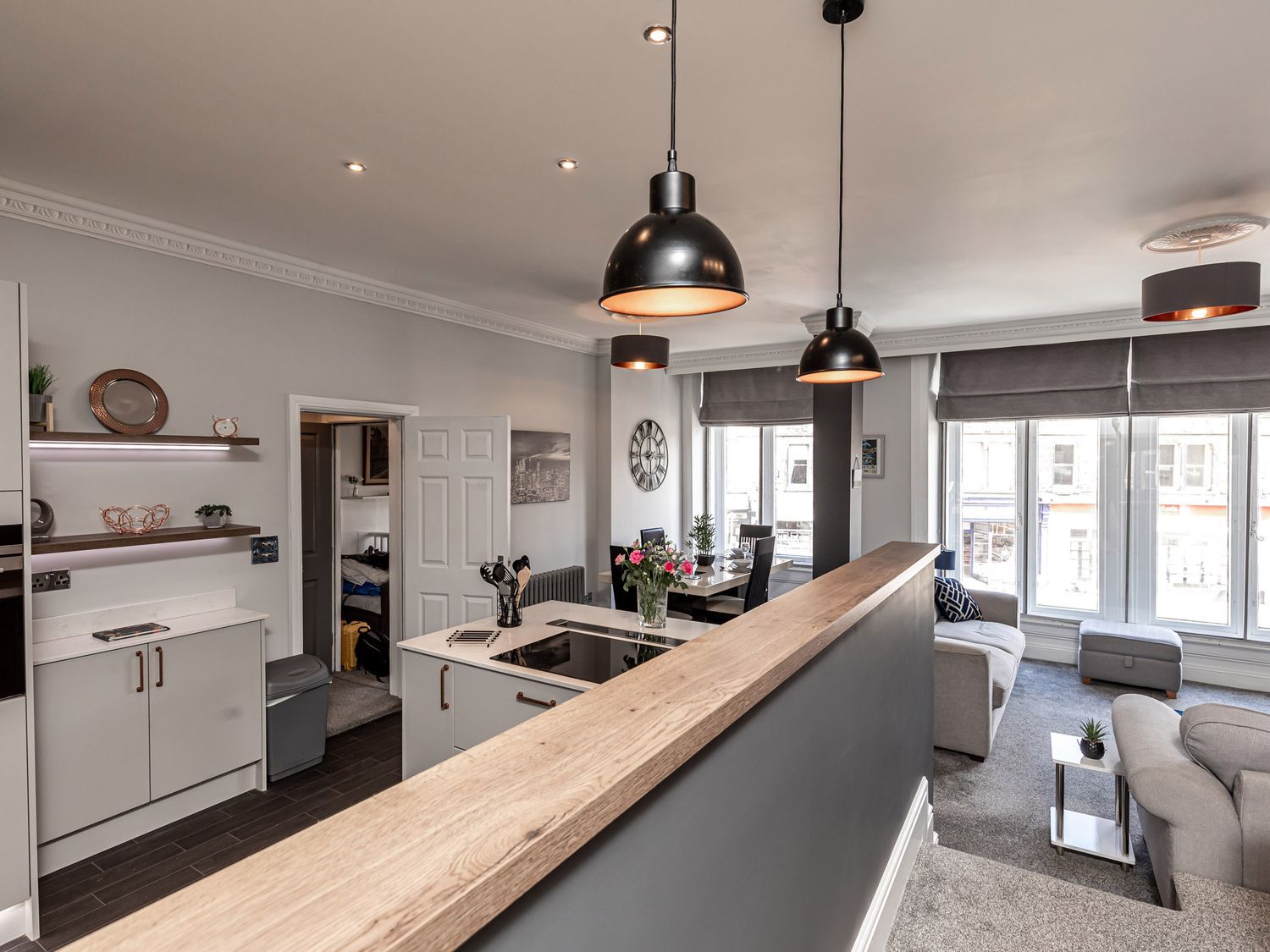 A living room with a kitchen and seating area at The Crows Nest in Buxton