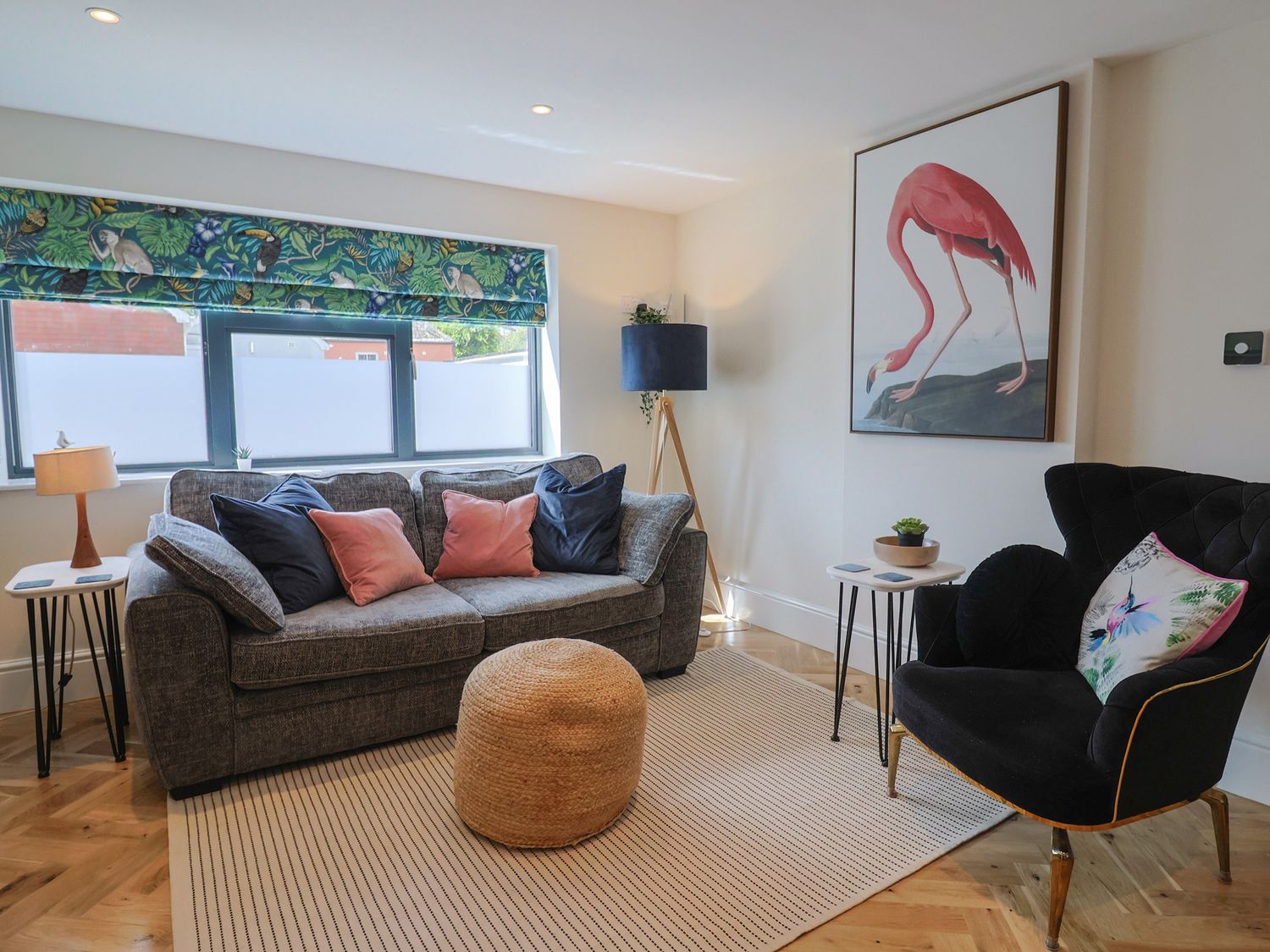 A living room with a sofa and lamp at 1 Mill Green Court Lyme Regis